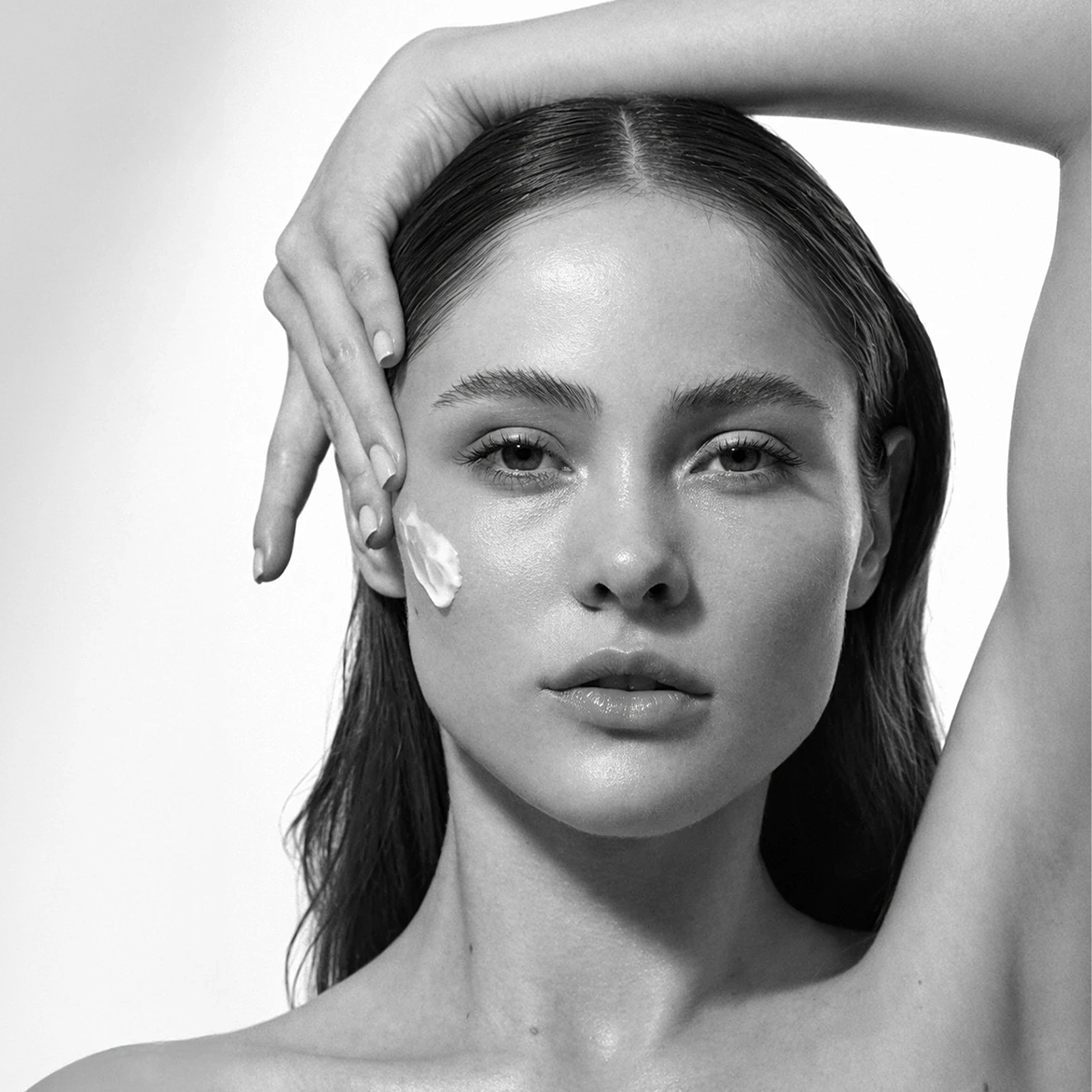 Black and white photo of a woman with THAT CREAM with peptides and vitamins by Ahaa Skincare on her face
